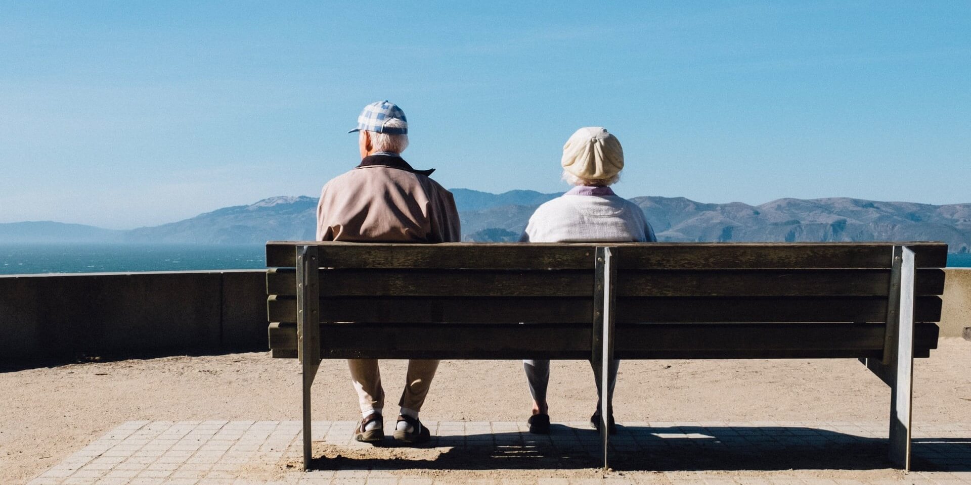senior couple on a bench senior couple sitting on a bench