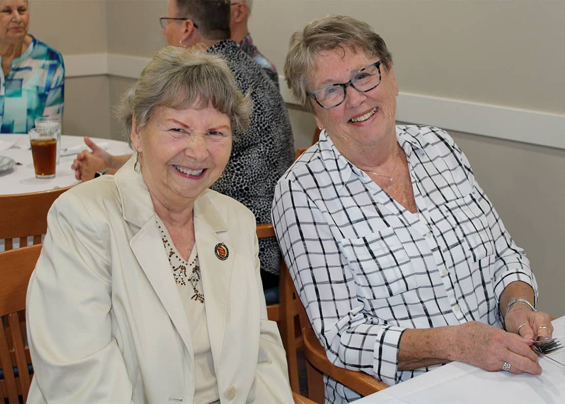 Two ladies sitting next to each other
